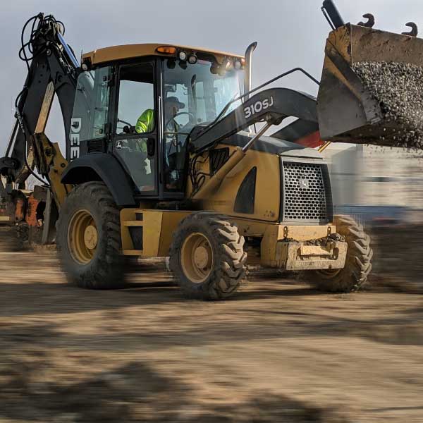 PRX Excavating in Denver, Colorado - John Deer 310 SJ Back Hoe for hire excavation services